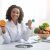 happy-woman-doctor-holding-orange-and-barbell-in-c-2025-03-18-19-27-15-utc.jpg